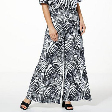 High-waisted black printed wide-leg pants on model - fashioncurb