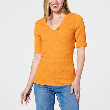 Front view of the DG2 Smocked Knit Twist Front Top in Ivory, a women's v-neck t-shirt with smocked knit texture and a flattering twist detail. - fashioncurb