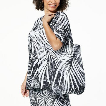 Side view of model wearing Stylish black top with vibrant printed graphic