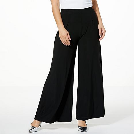 High-waisted black printed wide-leg pants on model - fashioncurb