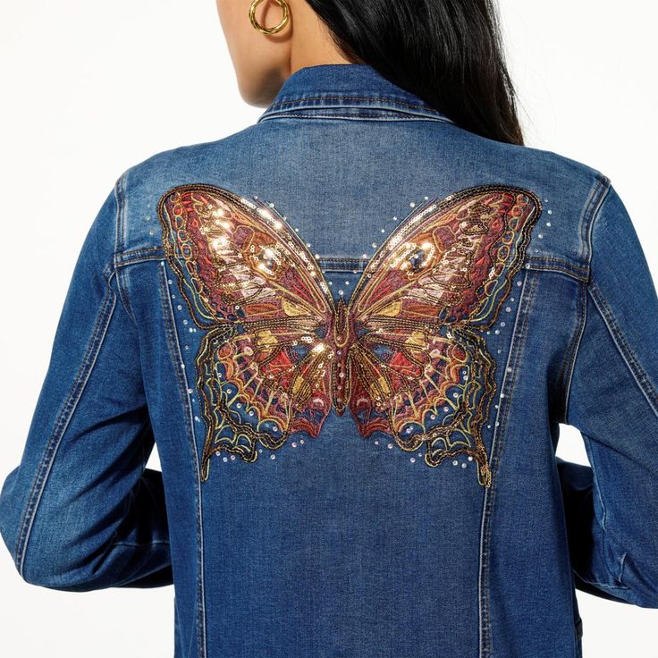 Close-up of Model Wearing DG2 by Diane Gilman denim jacket featuring an ornate, multicolor embroidered butterfly design with sequins on the back.r