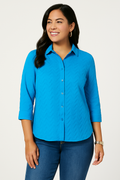 Jaclyn Smith Embroidered Cotton Voile Buttoned Shirt in vibrant blue, worn casually with medium-wash denim jeans. The model, with medium skin tone, smiles warmly in a relaxed, stylish look.
