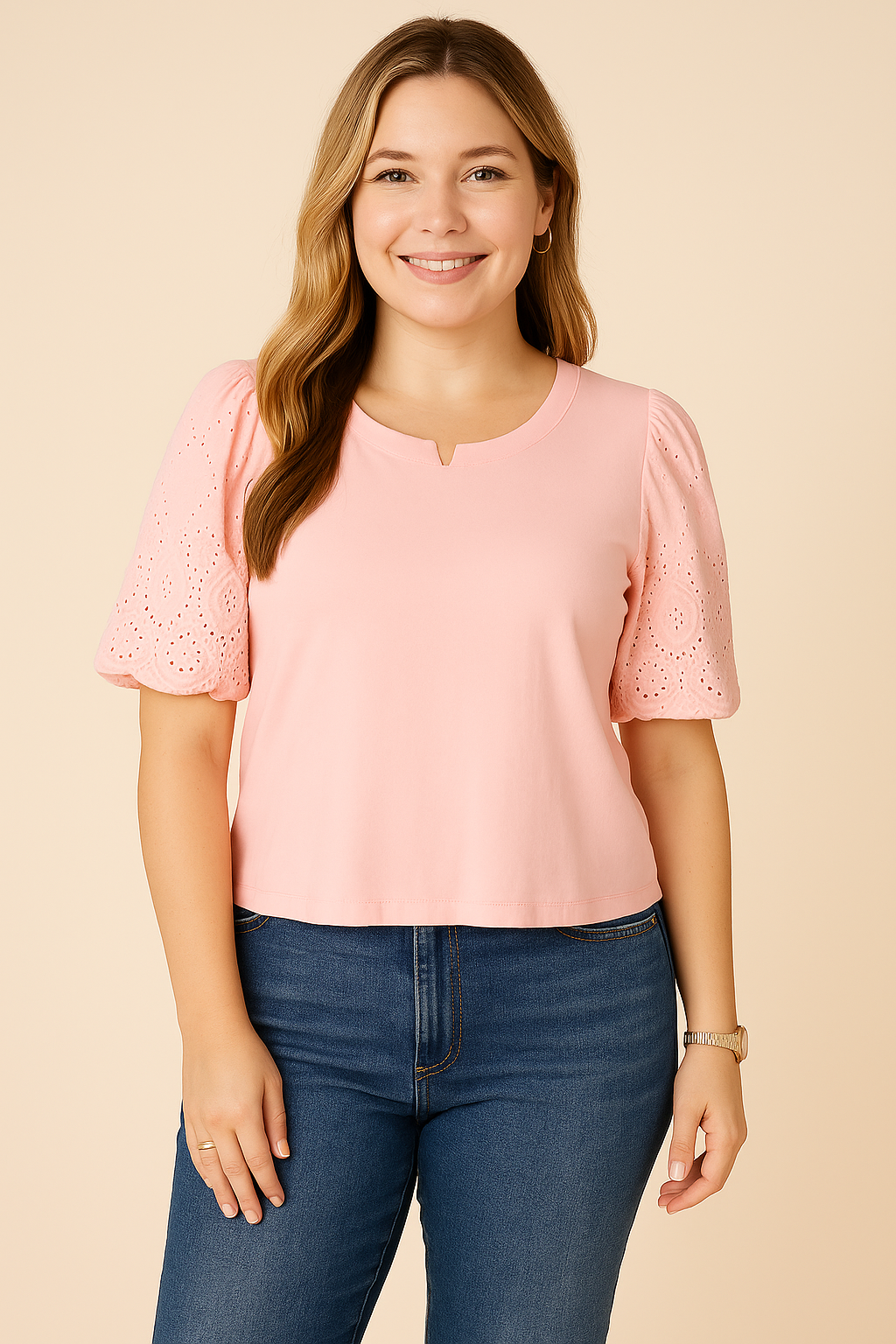 A young woman smiles while wearing a Democracy Embroidered Puff-Sleeve Top in white, paired with sleek navy blue tailored trousers. The top features delicate eyelet embroidery on the puff sleeves, giving it a sophisticated look. She accessorizes with gold hoop earrings, a delicate gold chain necklace, and a classic gold watch, creating a polished, semi-formal outfit against a soft beige background.