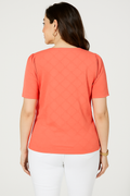 Back view of a woman wearing a Jaclyn Smith Eyelet Knit Puff Sleeve Tee in coral, styled with white pants. The delicate eyelet pattern is subtly visible on the back, enhancing the soft, elegant look.