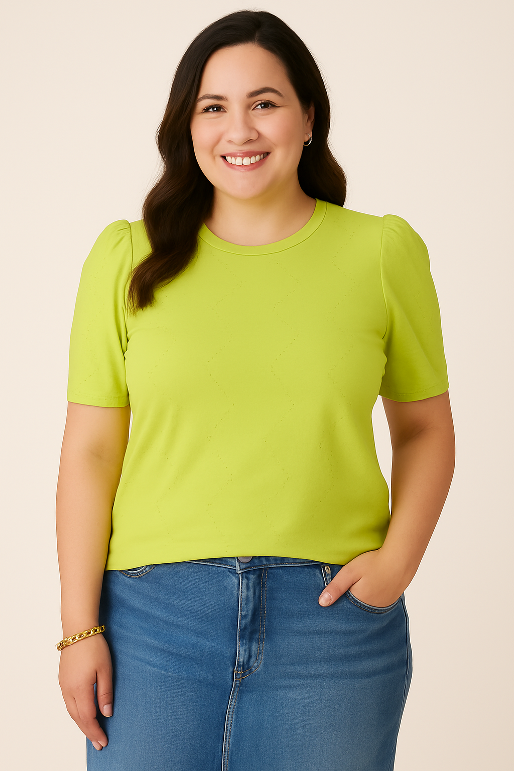Front view of a plus-size woman in a Jaclyn Smith Eyelet Knit Puff Sleeve Tee in bright lime green, paired with medium blue denim jeans. The soft fabric and delicate eyelet pattern add a touch of elegance.